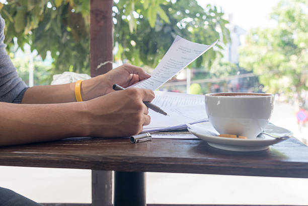 istock Businessman reading reports with the pen on his hand 520555740