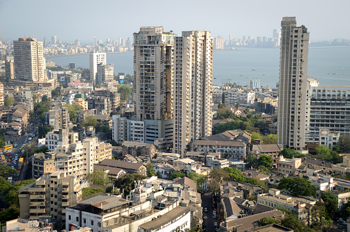 Aerial view of south Mumbai's skyline where old, heritage structures stand cheek by jowl with ultra modern skyscrapers and towers. The view covers and extends till luxurious Marine Drive, Nariman Point and Cuffe Parade with Arabian Sea in the distance