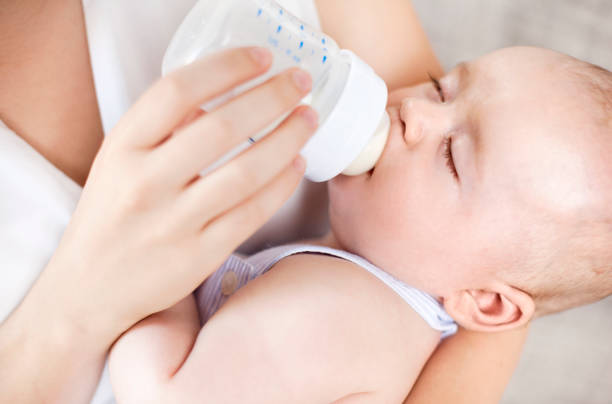 istock Mother feeding newborn baby 520562183