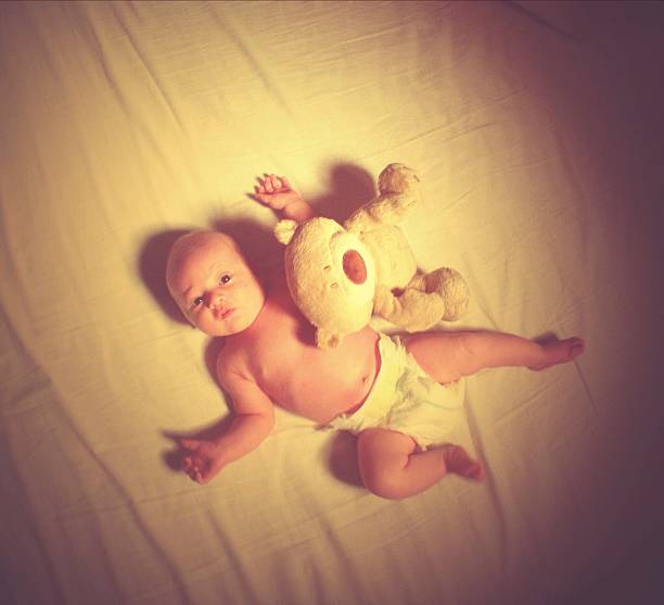 istock Newborn baby and her first Teddy Bear 520563437