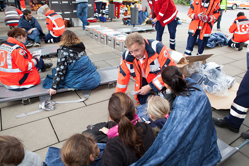 Wiesbaden, Germany - October 25, 2014: Large mass casualty drill with rescue services and emergency doctors in the city center of Wiesbaden. Several Paramedics are triaging injured victims. The displayed injuries and victims are NOT real, approximately 30 actors portrayed wounded or injured people which have been made up by a special team of makeup artists