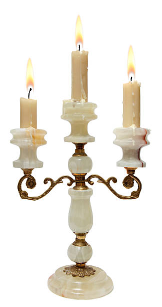 istock Burning Candle In Old Bronze With Onyx Candlestick Isolated  White 520567081