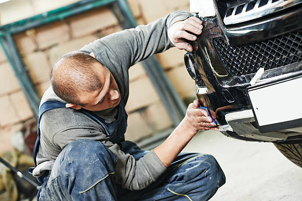 auto mechanic polishing car stock photo