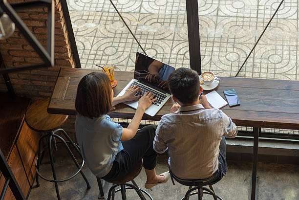 istock Woman showing data on laptop for the man taking note 520579636