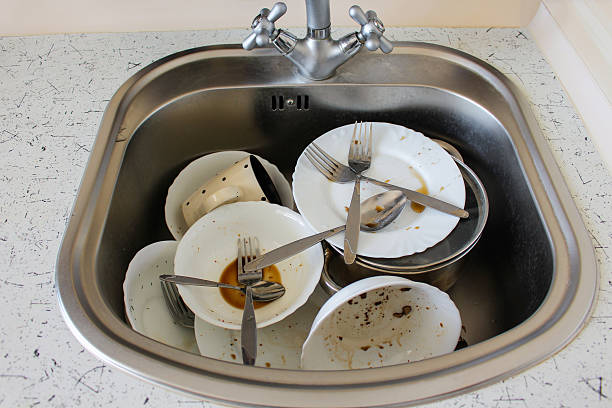 istock Dirty dishes: plates, cup, forks, spoons in sink 520580126