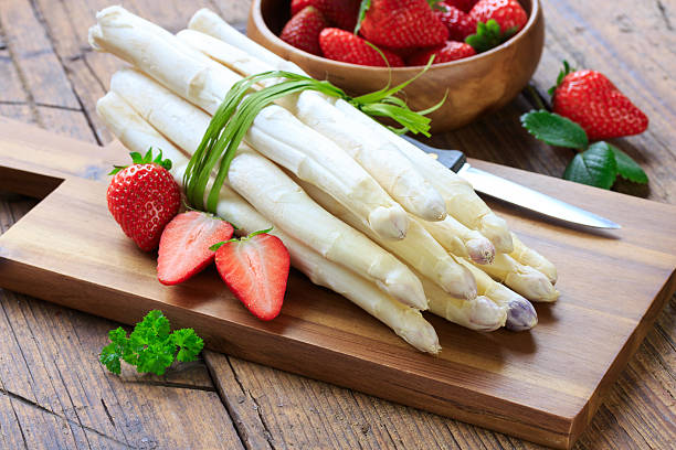 white asparagus and strawberries stock photo