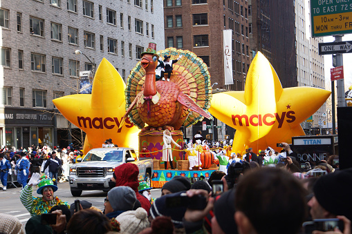 New York, United States - November 28, 2013: The 87th annual Macy's Thanksgiving Day parade attracted hundreds of thousands of spectators.  Turkey with Pilgrim riders