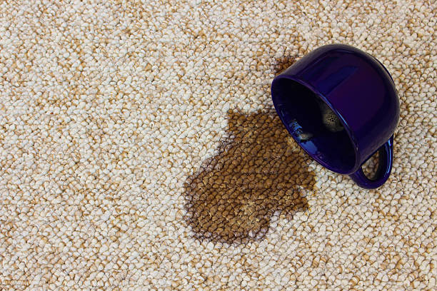 istock Coffee spilled from the cup on the carpet 520582780