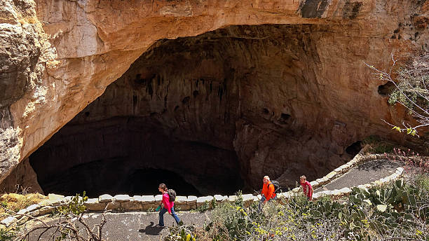 Carlsbad Caverns National Park Tourists Hiking the Natural Entrance Carlsbad, United States - April 12, 2016: Tourists hike the trail into and out of the Natural Entrance at Carlsbad Caverns National Park carlsbad texas stock pictures, royalty-free photos & images