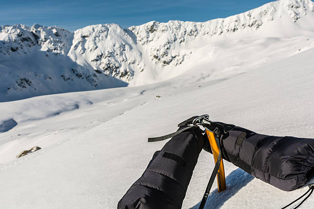istock Mittens and ice axe and a ridge in the background. 520588060