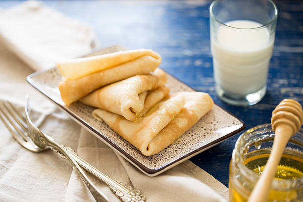 istock Crepes. Russian thin pancakes with honey. Breakfast table. 520591122
