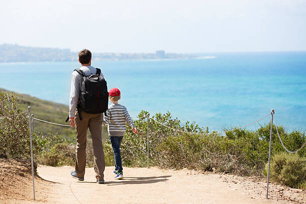 family hiking young active family of two hiking in torrey pines state natural reserve, concept of active and healthy lifestyle torrey pines state reserve stock pictures, royalty-free photos & images