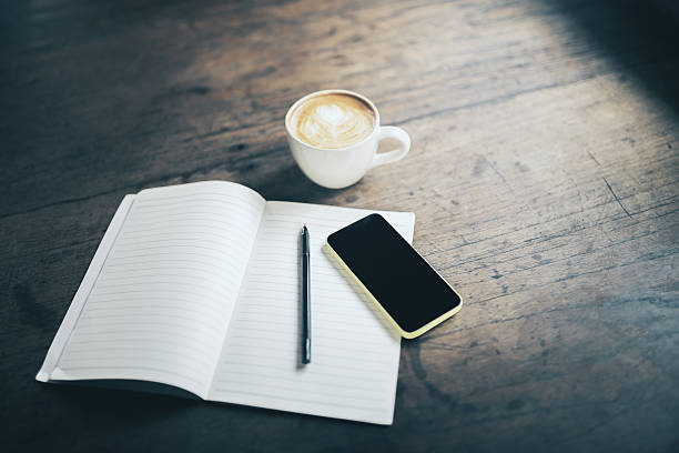 istock Open blank notebook, pen, cell phone and cup of coffee 520592288
