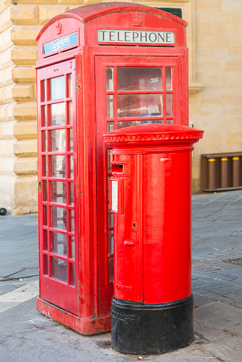 Red telephone booth and red mailbox in Valetta. Malta