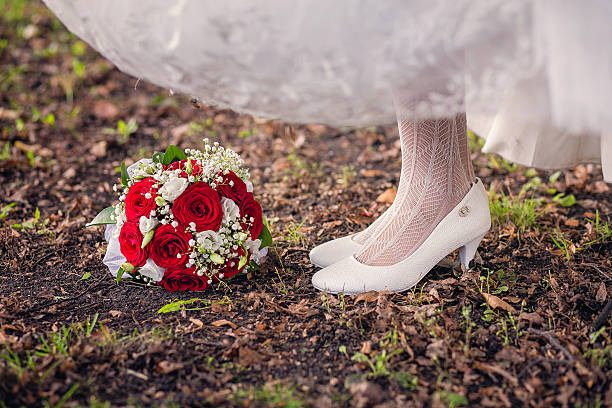 istock Bride's shoes and bouquet on the grass 520593154