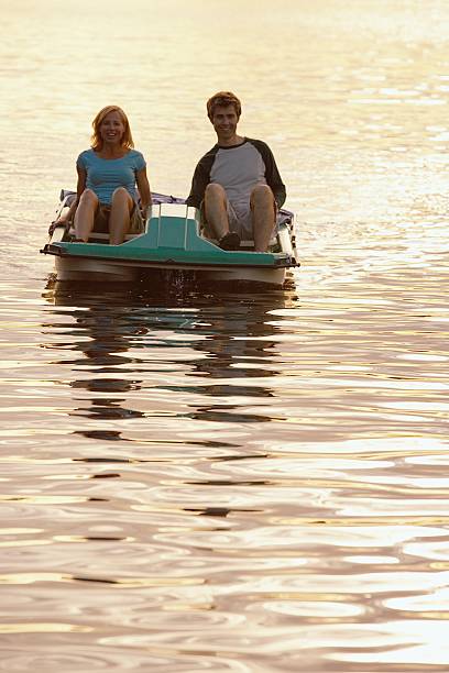 Couple on a lake Couple on a lake couple punting stock pictures, royalty-free photos & images