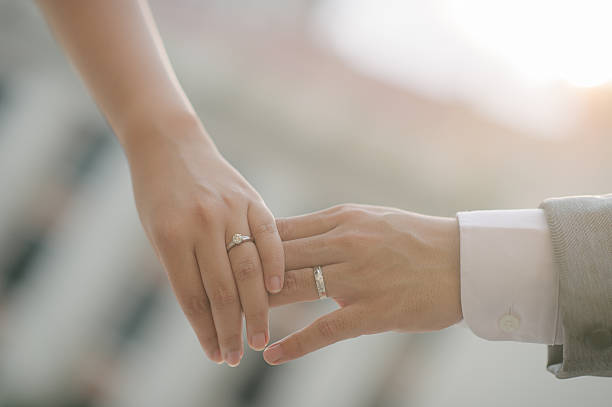 istock close up bride groom holding hand with sunset (selective focus) 520593928