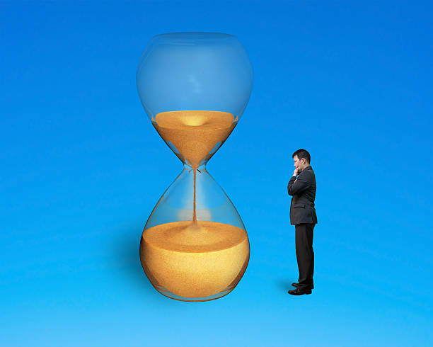 istock stand man watch hourglass 520598349