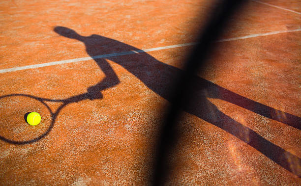 istock shadow of a tennis player in action 520598597