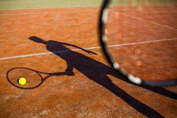 istock shadow of a tennis player in action 520599075