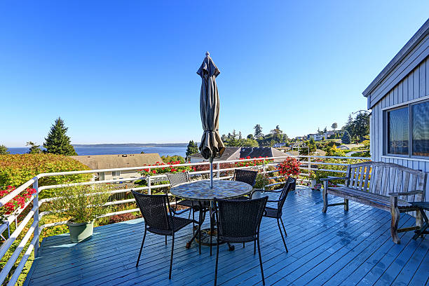 istock Walkout deck with patio area overlooking scenic bay view 520599849