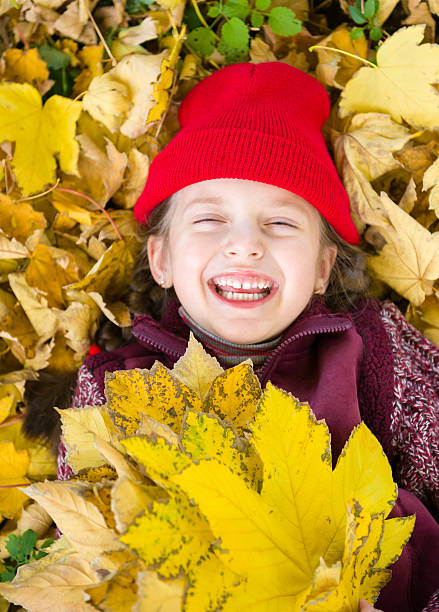 istock little girl in autumn park 520604613