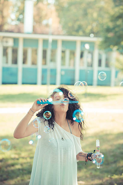 istock young beautiful moroccan curly woman blowing bubbles 520604677