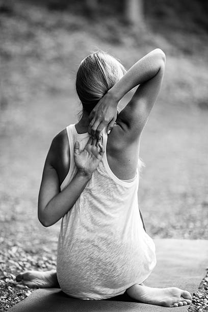 Young woman doing yoga, cow face position