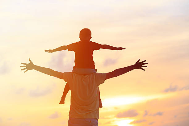 istock father and son play on sunset sky 520608774