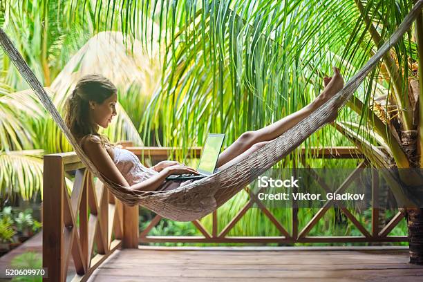 Young Woman Lying In A Hammock With Laptop Stock Photo - Download Image Now - Working, Vacations, Laptop