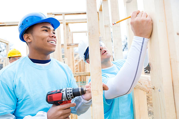 istock Men work together to build home for charity 520610730