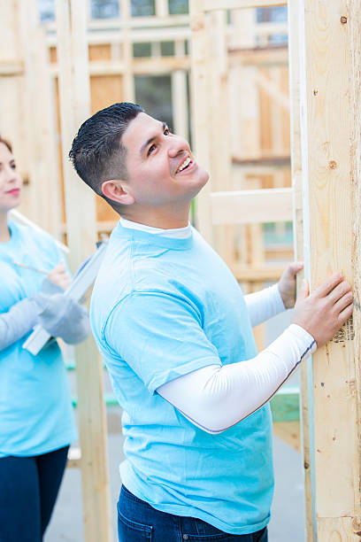 istock Male volunteer working on home built for charity 520611312