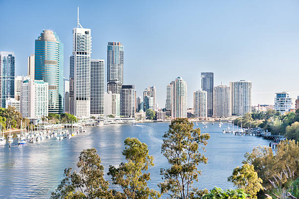 istock Huge city with tall buildings among trees and river 520611736