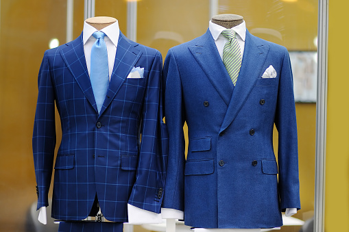 Beautiful blue suits with tie, tie clip and handkerchief on a mannequin