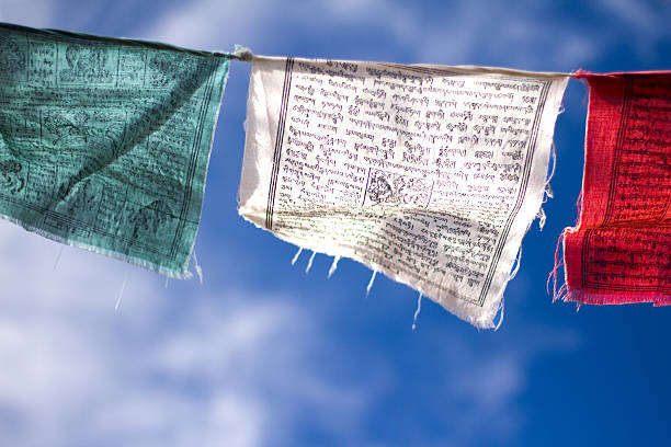 istock Tibetan Buddhist Prayer Flags Against Cloudy Blue Sky (Close-Up) 520612158