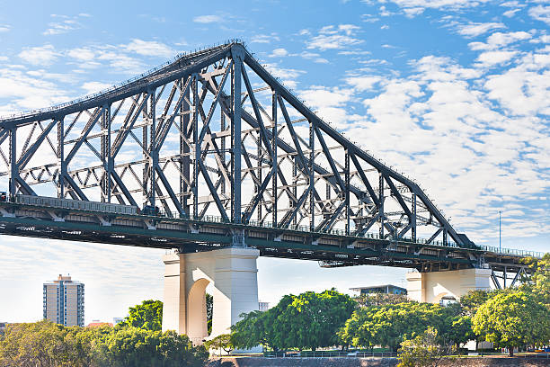 istock Huge metal bridge over the river and trees 520613980