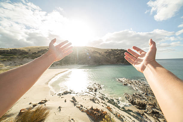 istock Woman's arms stretch towards a beautiful bay in Kangaroo Island 520615128