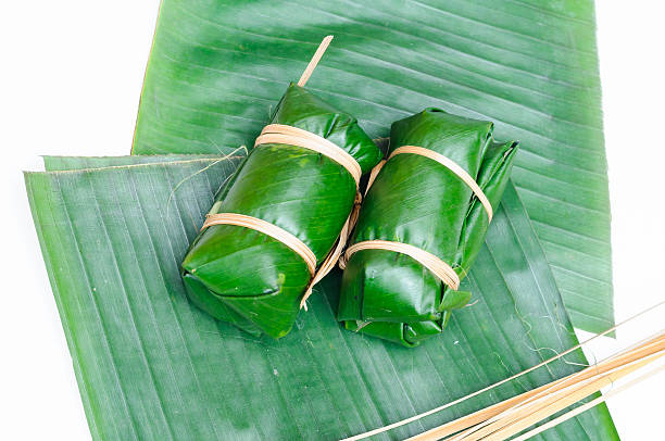 istock Thai dessert sticky rice steamed in banana leaf 520618253