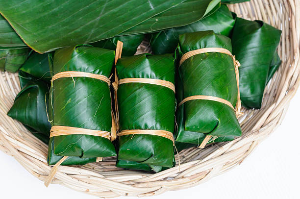 istock Thai dessert sticky rice steamed in banana leaf 520618261