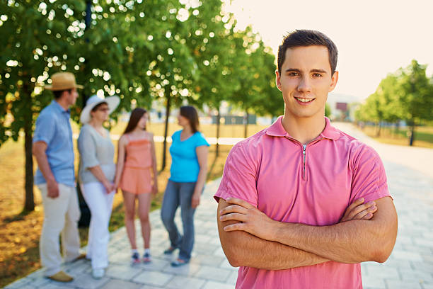 Sometimes they're embarassing, but I love them anyway Portrait of a smiling teenage boy at the park with his family in the backgroundhttp://www.azarubaika.com/iStockphoto/2014_08_09_Family3Generation.jpg anyway stock pictures, royalty-free photos & images