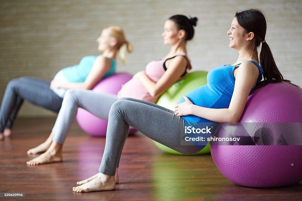 Exercise with ball Several pregnant women exercising with ball in gym Pregnant Stock Photo