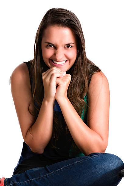 front view of a woman sitting on the floor looking at camera on white background