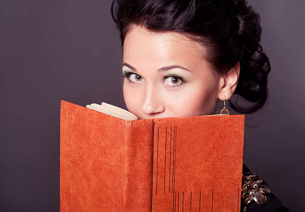istock Attractive woman reading over black 520622325