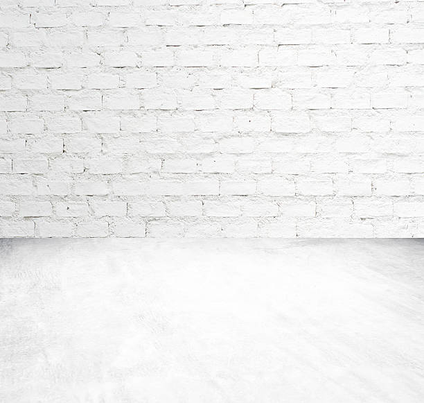 istock White brick wall and cement floor room in perspective 520622647
