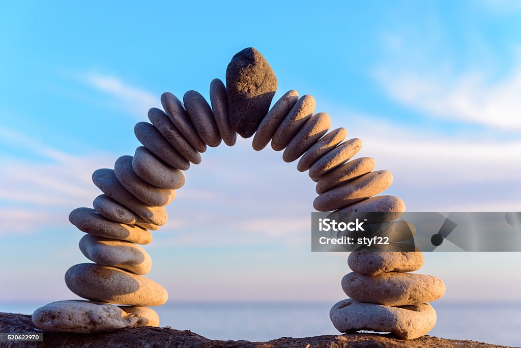 Perfect form of arch Pebbles in the form of a arch on the coast Balance Stock Photo