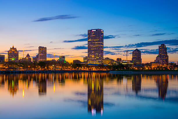 istock Milwaukee skyline with mirrorlike lake reflections and blue/orange/peach sunset 520623165