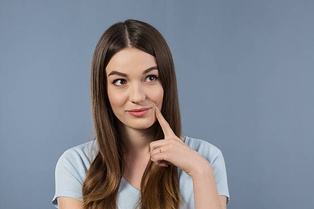 istock Beautiful girl standing on grey background 520623752