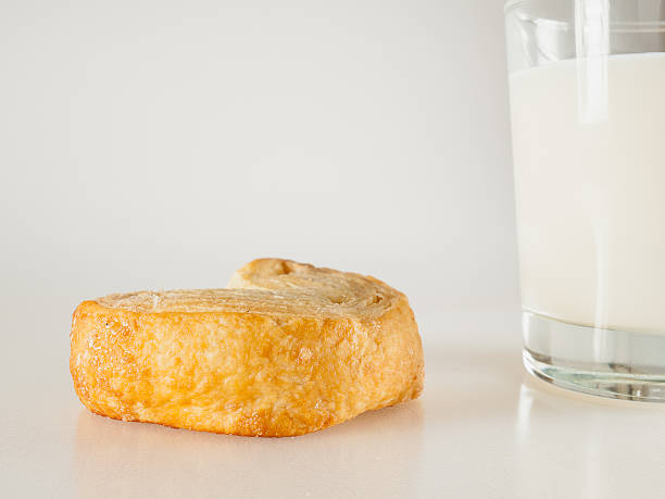 istock bun with a glass of milk on a white background 520637987