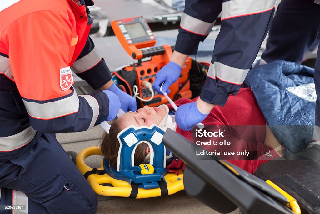 Mass Casualty Drill Wiesbaden, Germany - October 25, 2014: Large mass casualty drill with rescue services and emergency doctors in the city center of Wiesbaden. Paramedics are taking care of an injured female victim, preparing for transportation into the hospital. The displayed injuries and victims are NOT real, approximately 30 actors portrayed wounded or injured people which have been made up by a special team of makeup artists Accidents and Disasters Stock Photo