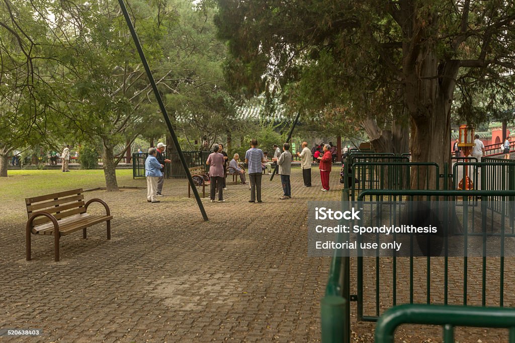 Temple of Heaven in Beijing Beijing, China - September 12, 2014: Retired old people get together in the Temple of Heaven Park every morning and do some stretch excerise together. Ancient Civilization Stock Photo